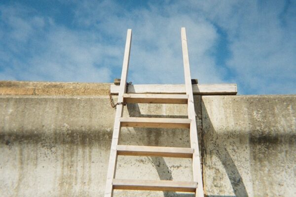 a ladder leaning up against a concrete wall