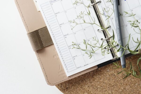 grey and black pen on calendar book