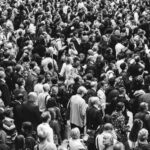 grascale photo of people standing on ground