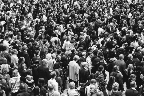 grascale photo of people standing on ground